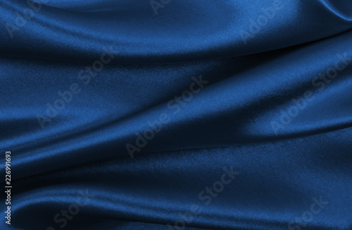 Smooth elegant blue silk or satin luxury cloth texture as abstract background. Luxurious background design