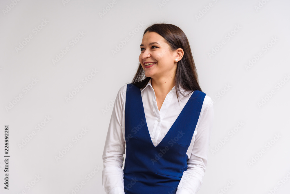 Studio portrait of a beautiful brunette girl on a white background with different emotions. Studio portrait of a beautiful brunette girl on a white background with different emotions.