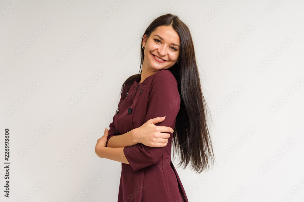 Studio portrait of a beautiful brunette girl on a white background with different emotions. Studio portrait of a beautiful brunette girl on a white background with different emotions.