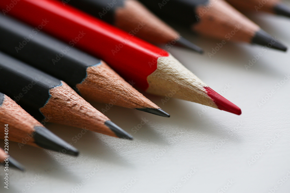 Red pencil standing out from crowd of plenty Red pencil standing out from crowd of plenty