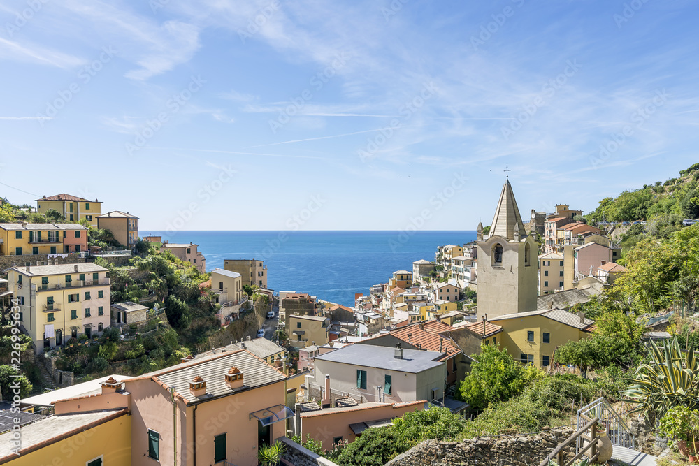 View of the seaside village of Riomaggiore and the Church of San Giovanni Battista, Cinque Terre, Liguria, Italy