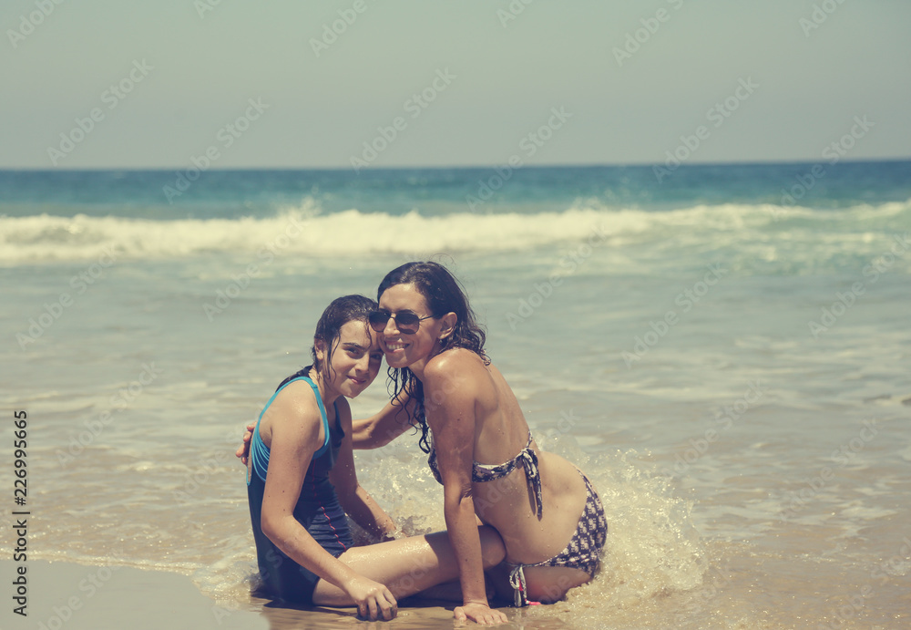 Mother and daughter having fun to spend time together on the beach at sunset Mother and daughter having fun to spend time together on the beach at sunset