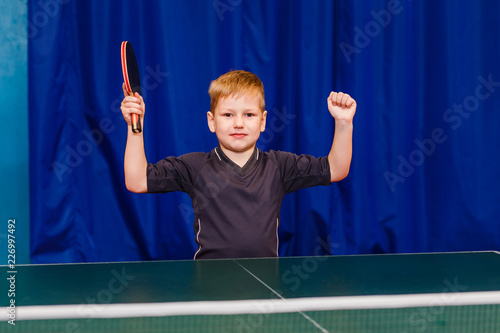 the child is happy to win in table tennis