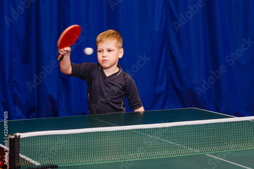 a child plays table tennis