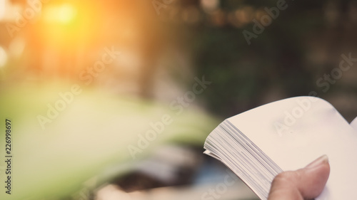 Man reading Book in his hands at garden