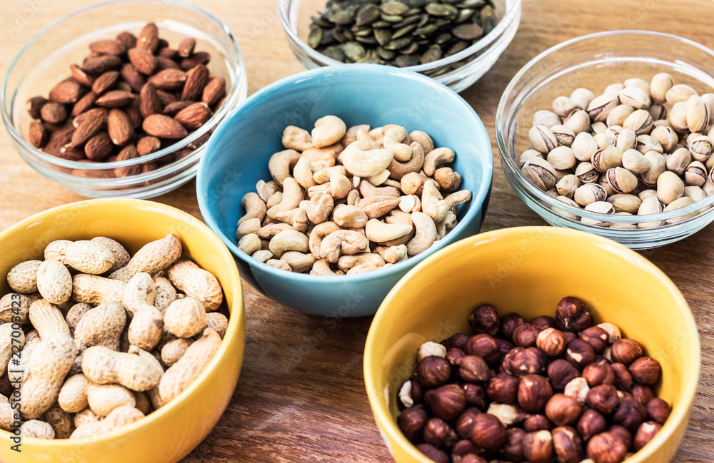 Assortment of mixed nuts on wood table background Assortment of mixed nuts on wood table background