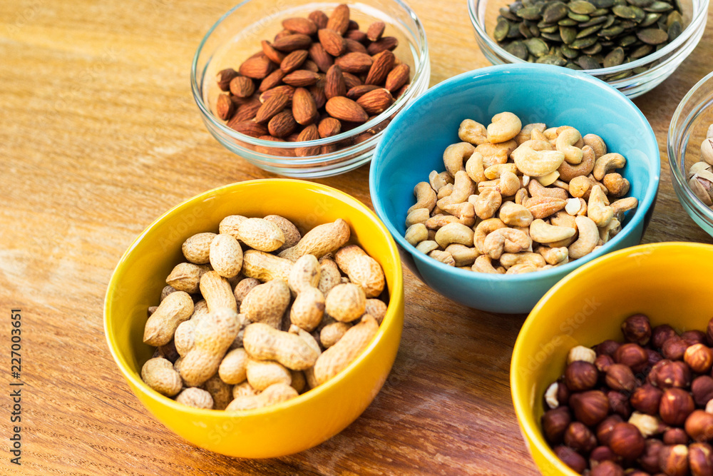 Assortment of mixed nuts on wood table background Assortment of mixed nuts on wood table background