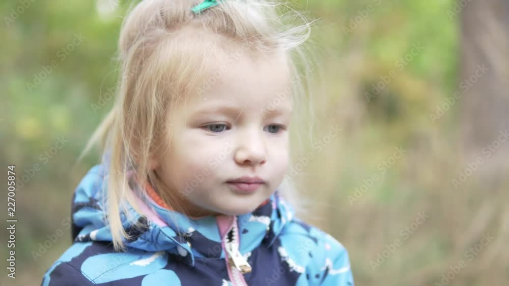 little girl walks in autumn park. close-up baby. nice video. The girl smiles coquettishly little girl walks in autumn park. close-up baby. nice video. The girl smiles coquettishly