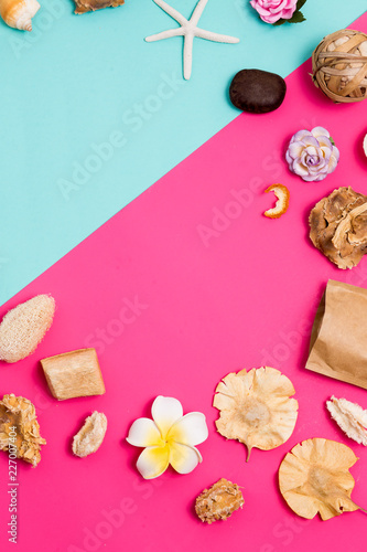 Beautiful Spa frame for text. Cosmetics products for body and face care on pink and blue background