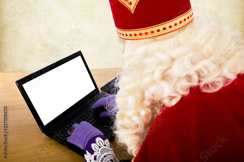 Sinterklaas with notebook or laptop photo