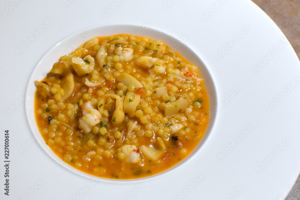 Sardinian fregola with fresh shrimp and cuttlefish, italian food specialties