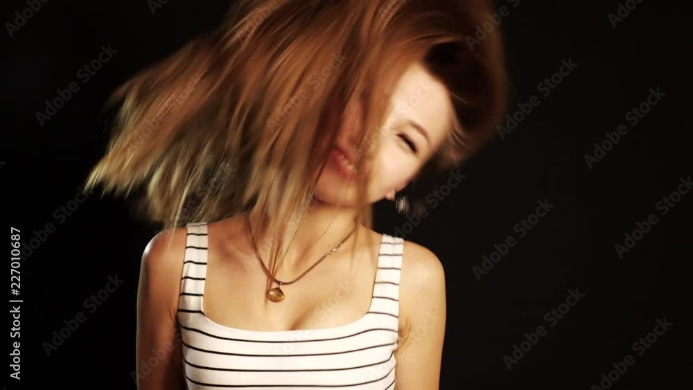 Happy Girl dancing on black background in studio. Studio shot. Slow motion Happy Girl dancing on black background in studio. Studio shot. Slow motion