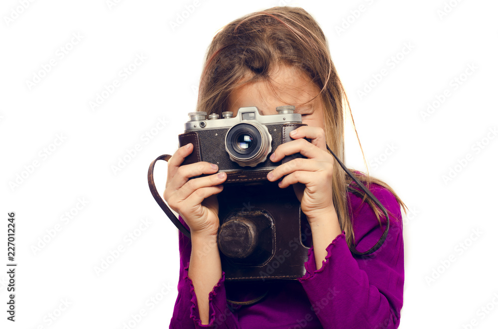 girl with a retro camera takes pictures on a white background girl with a retro camera takes pictures on a white background