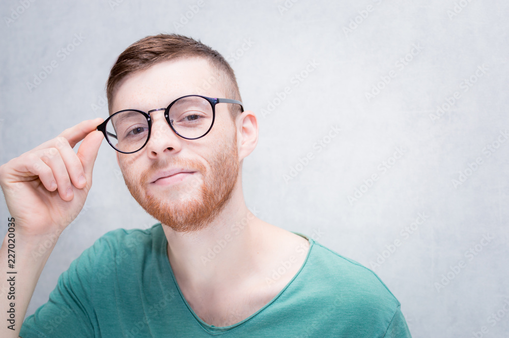 Young guy with glasses is smiling. Closeup portrait. Young guy with glasses is smiling. Closeup portrait.