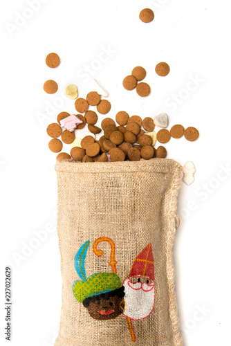 Pepernoten fall from jute bag with Sinterklaas and Zwarte piet