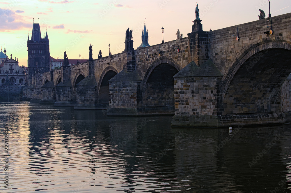 Scenic view of ancient Charles Bridge over Vltava River during summer sunrise. Close-up photo. Charles Bridge is one of the symbols of the Prague, Czech Republic