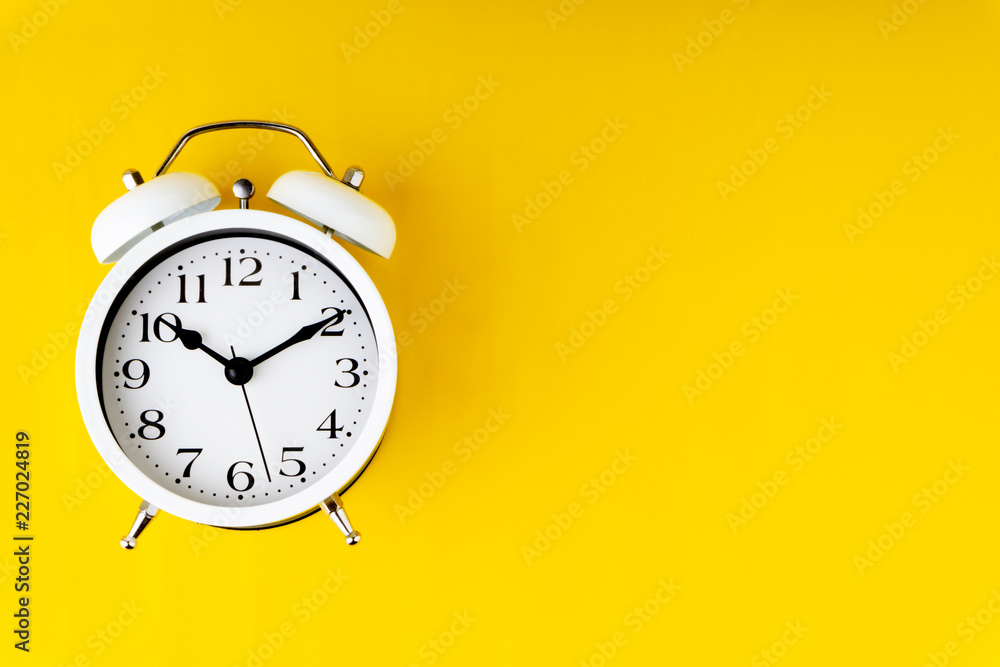 Clock on yellow background with selective focus and crop fragment. Copy space concept Clock on yellow background with selective focus and crop fragment. Copy space concept