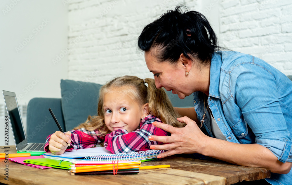 Frustrated mother and bored daughter doing homework together Frustrated mother and bored daughter doing homework together