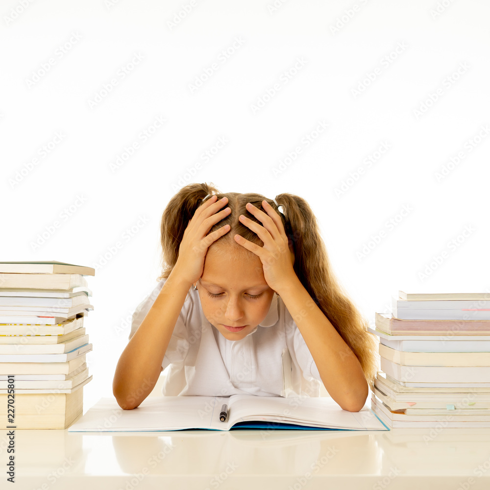 Sad unhappy cute little girl overwhelm with homework and studies Sad unhappy cute little girl overwhelm with homework and studies