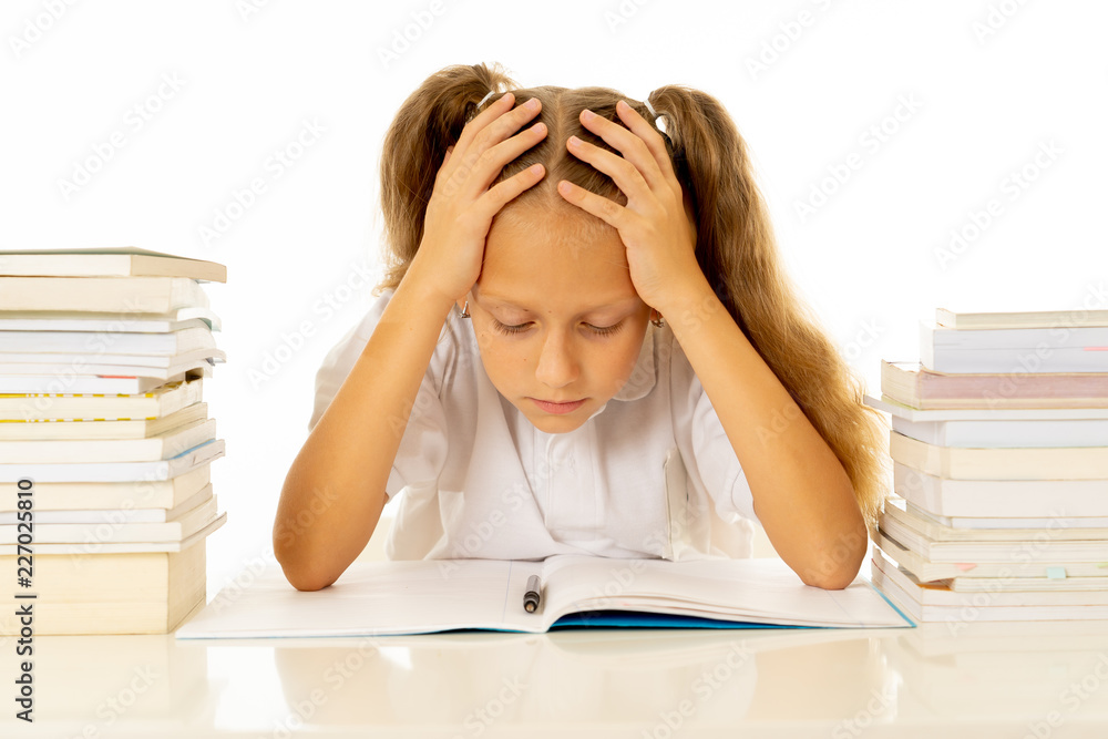 Sad unhappy cute little girl overwhelm with homework and studies Sad unhappy cute little girl overwhelm with homework and studies