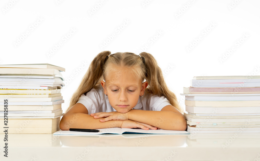 Sad unhappy cute little girl overwhelm with homework and studies Sad unhappy cute little girl overwhelm with homework and studies