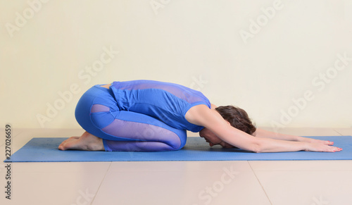 woman in child's pose yoga