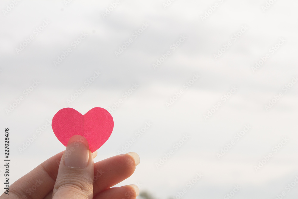 Hand holding Pink paper heart shape with copy space,love valentine concept. Hand holding Pink paper heart shape with copy space,love valentine concept.
