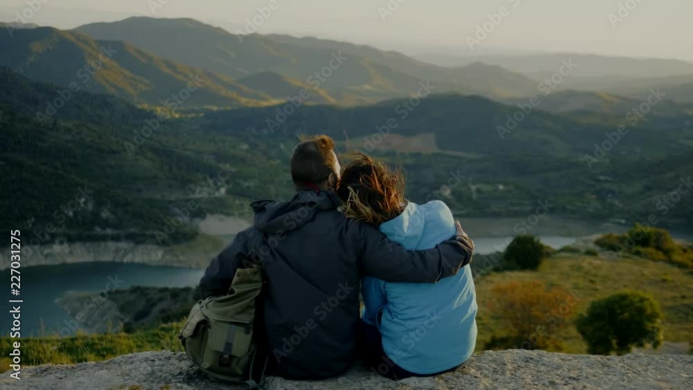Couple standing on top of mountain Couple standing on top of mountain