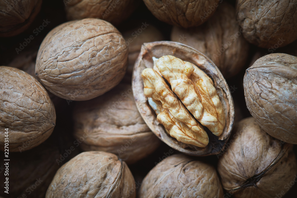 Closeup of whole and kernel walnuts. Top view Closeup of whole and kernel walnuts. Top view