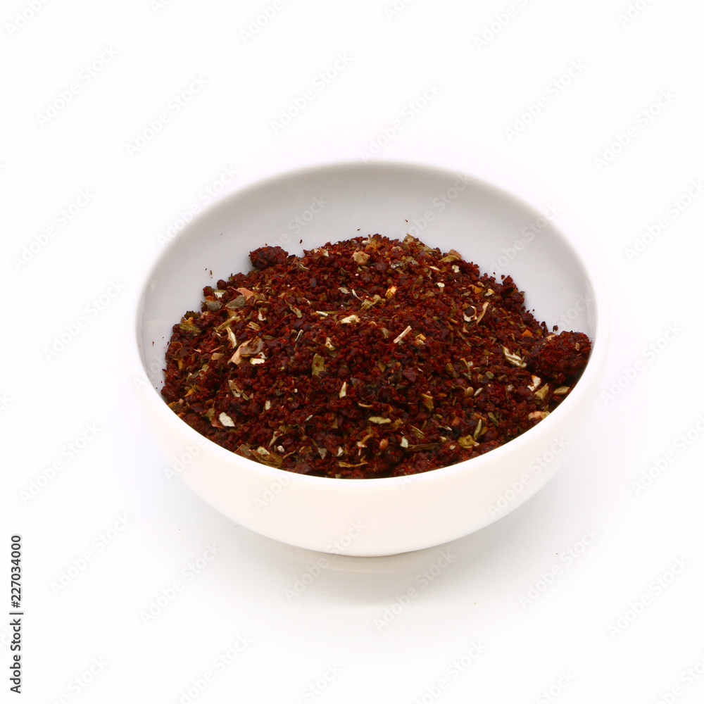 spices for meat and fish in a white ceramic cup, isolated