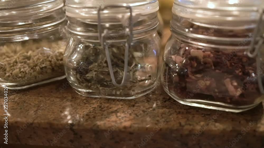 Dried herbs in glass jars close-up dertail Dried herbs in glass jars close-up dertail