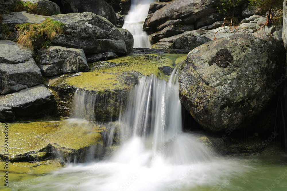 small waterfall in mountains