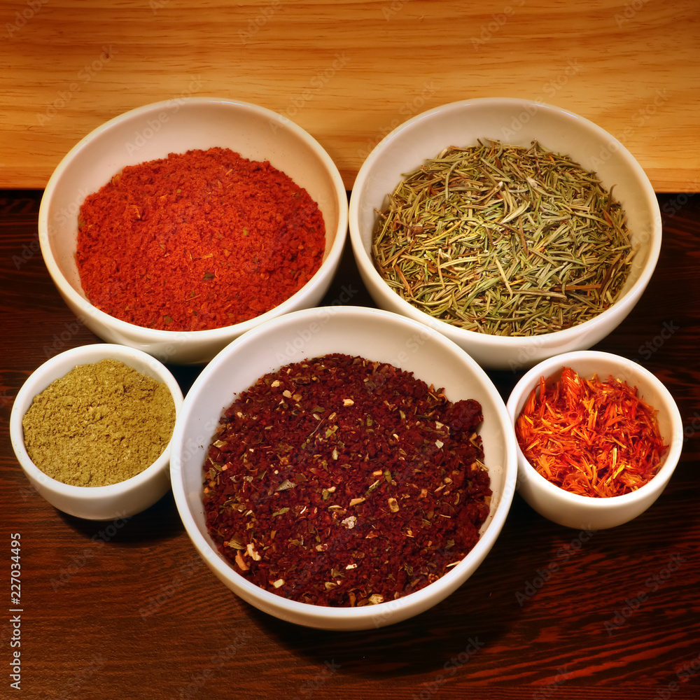 different spices in a white ceramic cup different spices in a white ceramic cup