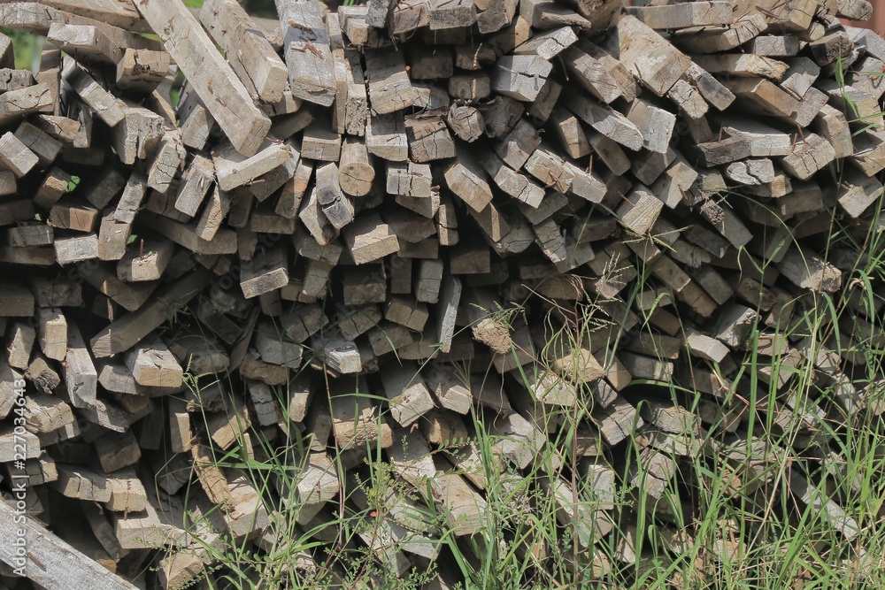 construction wood heap. badly pile wood on moisture dirt floor. wrong way of wood treatment. construction wood heap. badly pile wood on moisture dirt floor. wrong way of wood treatment.