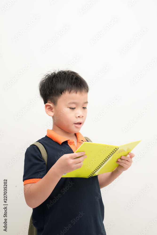 Happy little boy with book isolated on white background Happy little boy with book isolated on white background