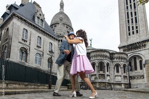 A couple of lovers dressed retro style dancing  in the streets of Montmartre, Paris, France © Dom