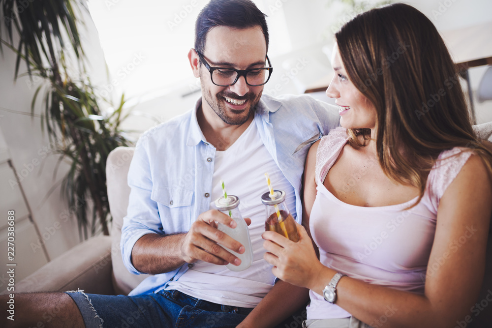 Happy attractive couple drinking together at home Happy attractive couple drinking together at home