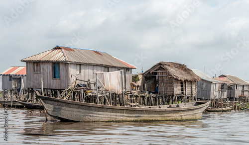 Fisherman fishing in Ganvié in Benin lake Nokoué lifestyle African villager living on house in water. Trading with barter system. West-Africa life in Ganvie Benin living with boats on lake.