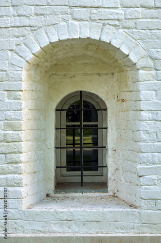 Narrow window in the wall of an ancient building in the Joseph-Volotsky russian monastery