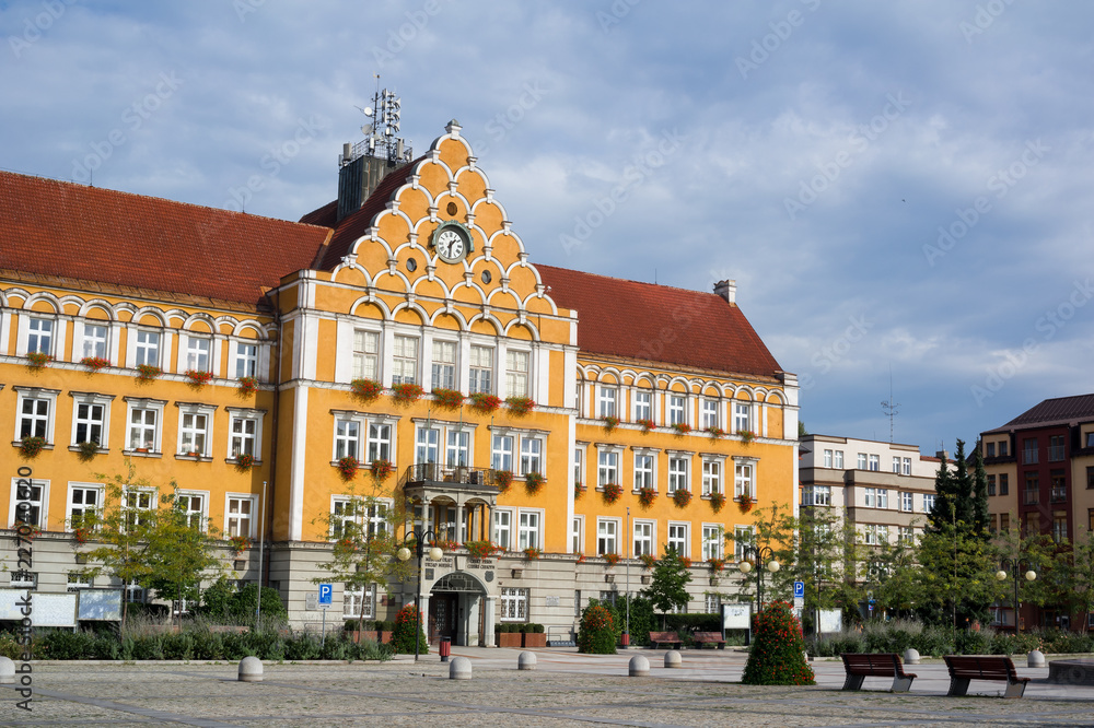Naklejka premium Mestsky urad / Urzad miejski ( Town hall ), Cesky Tesin / Czeski Cieszyn, Silesia, Czech Republic, Central Europe - square and orange building of municipality made in neo-renaissance style