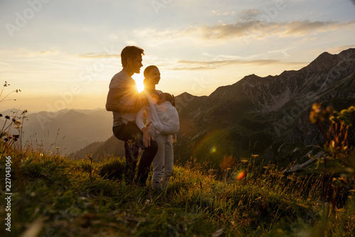 Germany, Bavaria, Oberstdorf, family with little daughter on a hike in the mountains at sunset