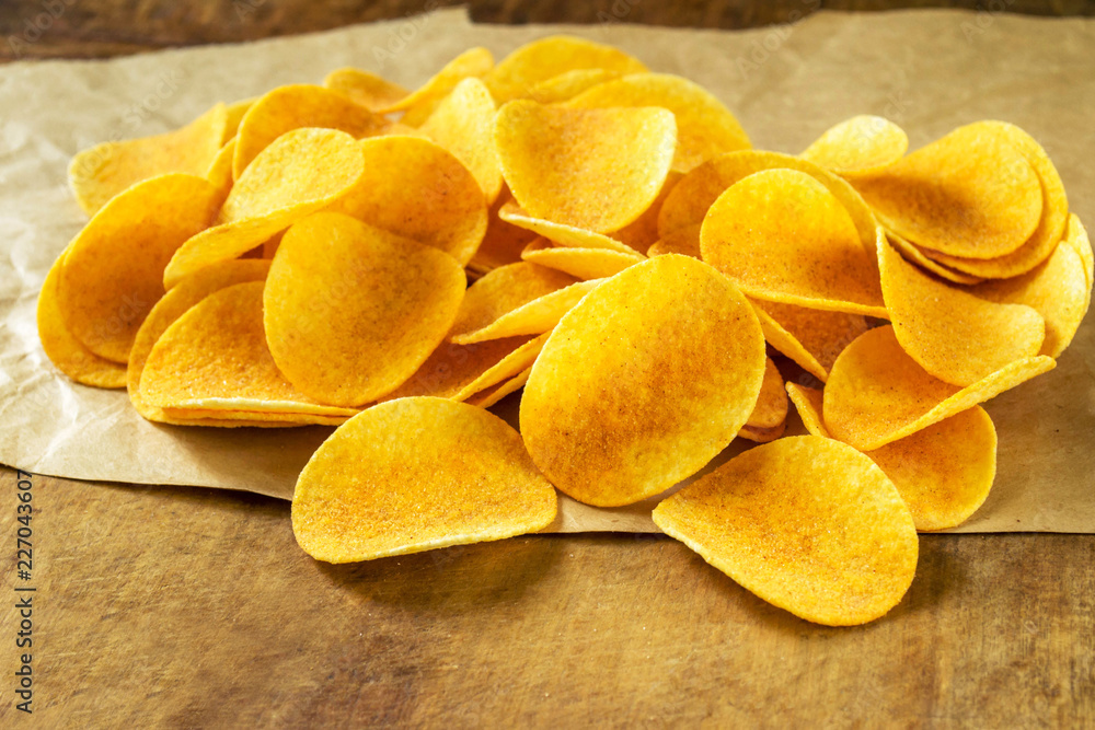 Potato flat chips on wrapping paper