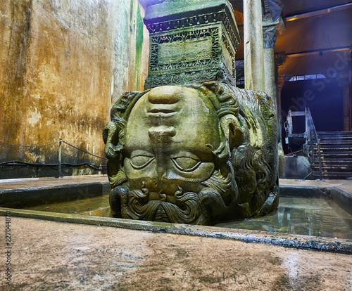 Upside-down head of Medusa located at the northwest edge of the subterranean Basilica Cistern, also known as Yerebatan Sarnici. Istanbul, Turkey. photo