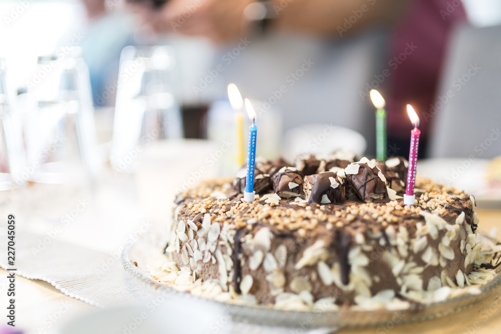 Lighted birthday candles on a cake Stock Photo | Adobe Stock