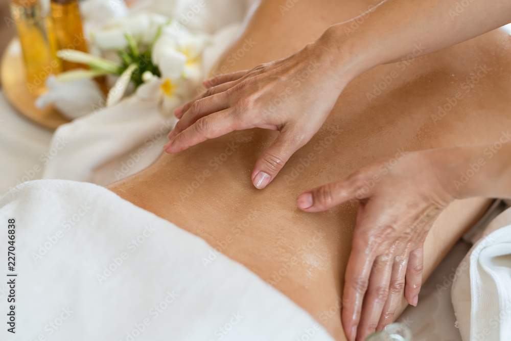 Young beautiful Asian woman sleep relaxing in the Oil spa massage in salon. Select focus hand of masseuse Young beautiful Asian woman sleep relaxing in the Oil spa massage in salon. Select focus hand of masseuse
