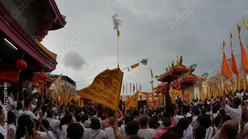 Phuket,Thailand- 8 October 2018- At Juitui Shrine, raise up sacred bamboo pole with 9 lamps, symbol of beginning vegetarian festival. Chinese god spiritual medium pray for god and moving holy flag.