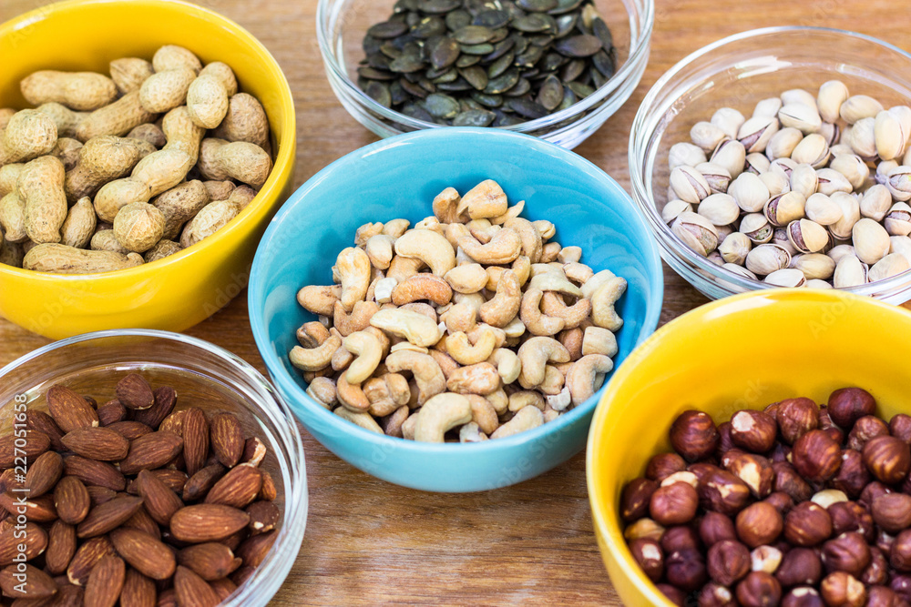 Assortment of mixed nuts on wood table background Assortment of mixed nuts on wood table background