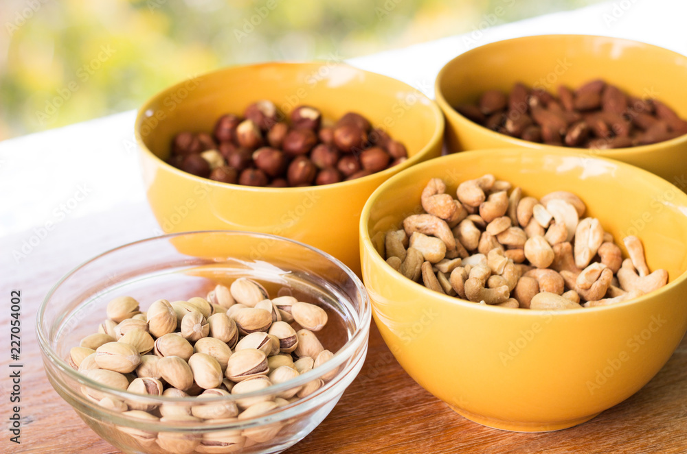 Assortment of mixed nuts on wood table background Assortment of mixed nuts on wood table background