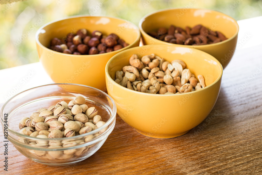 Assortment of mixed nuts on wood table background Assortment of mixed nuts on wood table background