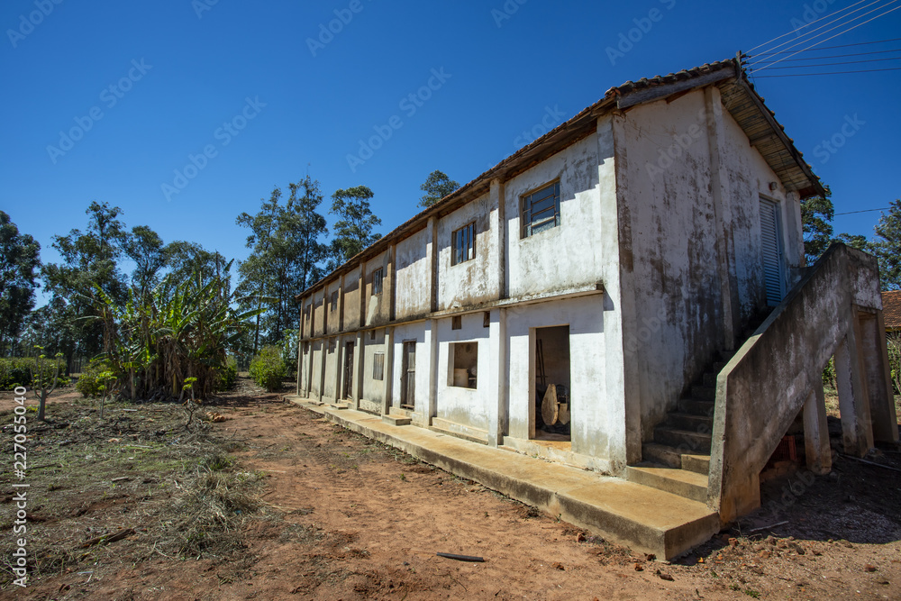 Simple farmhouse. Brick house, red roof, red earth farm, Brazil, South America 